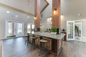 A kitchen with a bar area and a plant on the counter.
